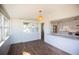 Bright dining area with wood-look flooring and access to the kitchen at 5713 12Th S Ave, Gulfport, FL 33707