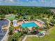 Community pool and recreational area with a playground at 6751 Boulder Run Loop, Wesley Chapel, FL 33545