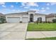 Two-story house with a three-car garage and landscaped yard at 6751 Boulder Run Loop, Wesley Chapel, FL 33545