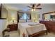 Spacious main bedroom with wood furniture and ensuite bathroom at 7064 Towne Lake Rd, Riverview, FL 33578