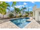 Refreshing rectangular pool surrounded by lush landscaping at 9111 Gulf Blvd, St Pete Beach, FL 33706