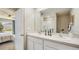 Double vanity bathroom with modern design and large mirror at 10831 Hidden Banks Gln, Parrish, FL 34219
