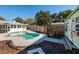 Beautiful kidney-shaped pool with a wooden shed and fenced yard at 1161 Jackson Rd, Clearwater, FL 33755