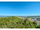 Aerial view showing waterfront property, highway, and lush landscaping at 12077 Gandy N Blvd # 374, St Petersburg, FL 33702