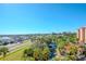 Aerial view of property showcasing a pond, highway, and palm trees at 12077 Gandy N Blvd # 374, St Petersburg, FL 33702