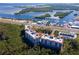 Aerial view of condo building near waterfront, highway, and marina at 12077 Gandy N Blvd # 374, St Petersburg, FL 33702