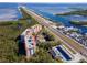 Aerial view of waterfront condo building with pool and surrounding landscape at 12077 Gandy N Blvd # 374, St Petersburg, FL 33702