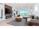 Living room with fireplace, water view, and light wood floors at 12077 Gandy N Blvd # 374, St Petersburg, FL 33702