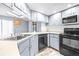 Kitchen with stainless steel appliances and light gray cabinets at 1257 Waterfall Dr, Spring Hill, FL 34608