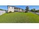 Large backyard with a two-story home in the background at 12609 Pensacola Ct, Riverview, FL 33579