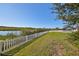 Spacious backyard with white fence and water view at 12609 Pensacola Ct, Riverview, FL 33579
