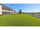 Spacious backyard with a large lawn and lake view at 12609 Pensacola Ct, Riverview, FL 33579