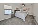 Serene bedroom with a queen-size bed, built-in shelving, and gray carpeting at 12609 Pensacola Ct, Riverview, FL 33579