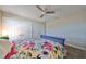 Bedroom with purple bed frame, floral bedding, and ceiling fan at 12609 Pensacola Ct, Riverview, FL 33579