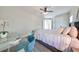 Comfortable bedroom with a queen-size bed, desk, and ceiling fan at 12609 Pensacola Ct, Riverview, FL 33579