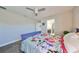 Bedroom with purple bed frame, floral bedding, and ceiling fan at 12609 Pensacola Ct, Riverview, FL 33579