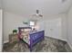 Charming bedroom with purple bed frame, floral bedding, and ceiling fan at 12609 Pensacola Ct, Riverview, FL 33579