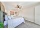 Bright bedroom with a queen-size bed, ceiling fan, and gray carpeting at 12609 Pensacola Ct, Riverview, FL 33579
