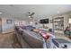 Bonus room with sectional sofa, TV, and bookcase offering ample living space at 12609 Pensacola Ct, Riverview, FL 33579