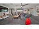 Spacious bonus room features a large sectional sofa, flat-screen TV, and built-in shelving at 12609 Pensacola Ct, Riverview, FL 33579