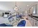 Bright dining area with glass table and blue velvet chairs at 12609 Pensacola Ct, Riverview, FL 33579