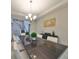 Modern dining room with a dark wood table and white chairs at 12609 Pensacola Ct, Riverview, FL 33579