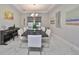 Elegant dining room with a large table and modern chandelier at 12609 Pensacola Ct, Riverview, FL 33579
