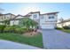 Two-story house with stone accents, a three-car garage, and lush landscaping at 12609 Pensacola Ct, Riverview, FL 33579