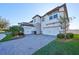 Two-story home with stone and white exterior and a two-car garage at 12609 Pensacola Ct, Riverview, FL 33579