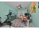 Bright home office with Peloton bike, standing desk, and ample natural light at 12609 Pensacola Ct, Riverview, FL 33579