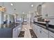 Modern kitchen with gray cabinets, stainless steel appliances and a large island at 12609 Pensacola Ct, Riverview, FL 33579