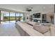 Living room with sectional sofa, large windows, and backyard view at 12609 Pensacola Ct, Riverview, FL 33579