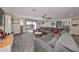 Relaxing living room with sectional sofa, built-in shelving, and balcony access at 12609 Pensacola Ct, Riverview, FL 33579