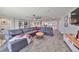 Spacious living room with sectional sofa, a large window, and access to a balcony at 12609 Pensacola Ct, Riverview, FL 33579