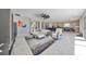 Open concept living room with sectional sofa and access to backyard at 12609 Pensacola Ct, Riverview, FL 33579
