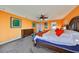 Spacious main bedroom with king bed, dresser, and orange walls at 12609 Pensacola Ct, Riverview, FL 33579