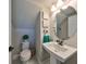Elegant powder room with a pedestal sink, round mirror, and marble flooring at 12609 Pensacola Ct, Riverview, FL 33579