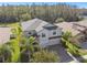 Two-story house with gray roof, two-car garage, and landscaping at 12660 Mountain Springs Pl, New Port Richey, FL 34655