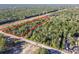 Aerial view of a rectangular lot in wooded area at 15535 Little Ranch Rd, Spring Hill, FL 34610