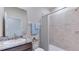 Clean bathroom with a shower/tub combo, granite vanity, and neutral tile at 16033 7Th E Ave, Bradenton, FL 34212