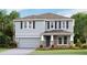 Charming two-story home with stone accents, a two-car garage, and a well-manicured lawn at 16033 7Th E Ave, Bradenton, FL 34212