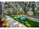 Artificial turf lawn, brick pathway, and lush landscaping at 17437 New Cross Cir, Lithia, FL 33547