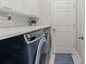 Laundry room with washer, dryer, and countertop space at 17437 New Cross Cir, Lithia, FL 33547