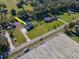 Aerial view of a house with a pool and a large yard near farmland at 1827 Joe Mcintosh Rd, Plant City, FL 33565