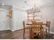 Charming dining room with a wooden table, four chairs and a crystal chandelier at 2260 E Vina Del Mar Blvd, St Pete Beach, FL 33706