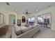 Bright living room with sliding glass doors leading to a patio and pool at 318 Noble Faire Dr, Sun City Center, FL 33573