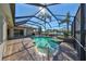 Inviting screened pool and spa with a serene lake view at 318 Noble Faire Dr, Sun City Center, FL 33573