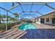 Enjoy this screened pool and spa with a beautiful lake view at 318 Noble Faire Dr, Sun City Center, FL 33573