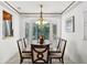 Elegant dining room boasting a large bay window and a formal dining table at 3220 W Bay Vista Ave, Tampa, FL 33611