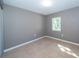 Bright bedroom with tile floors and window at 34740 Hibiscus Dr, Dade City, FL 33523